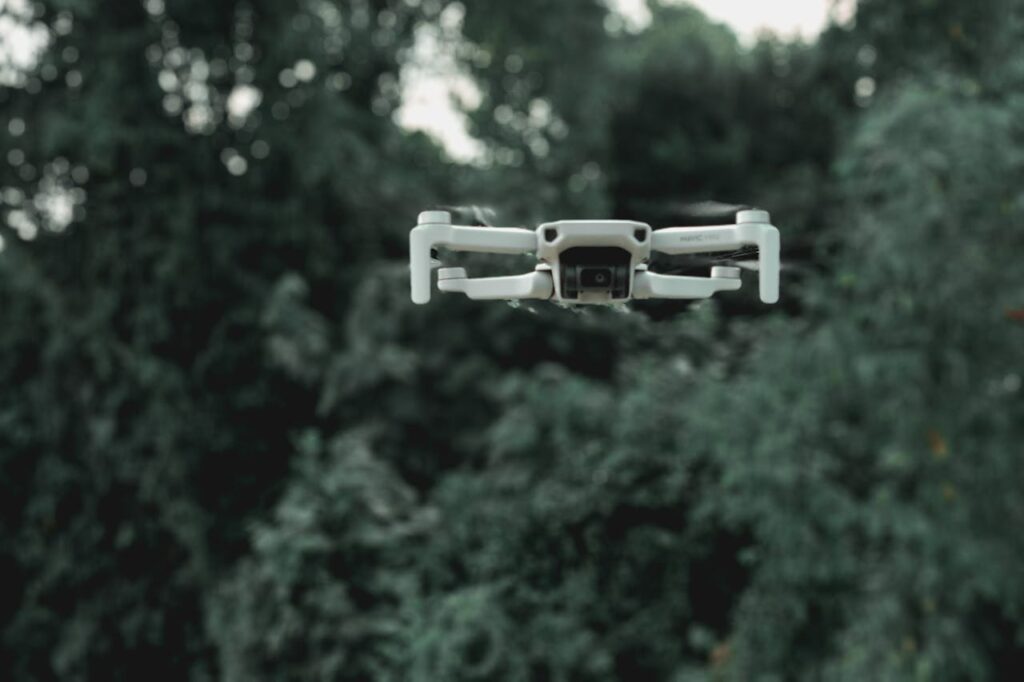 pexels-photo-3823555 Drone flying near green trees in forest